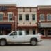 A pickup truck drives past an Arvest Bank branch on the square in Bentonville, Arkansas, U.S., on Thursday, May 28, 2020. The annual Walmart Inc. shareholder celebration attracts a varied crowd who pour money into the hotels, bars and restaurants in and around the retailer's hometown of Bentonville, Arkansas. The Covid-19 pandemic forced Walmart to pivot to a virtual gathering on June 3.