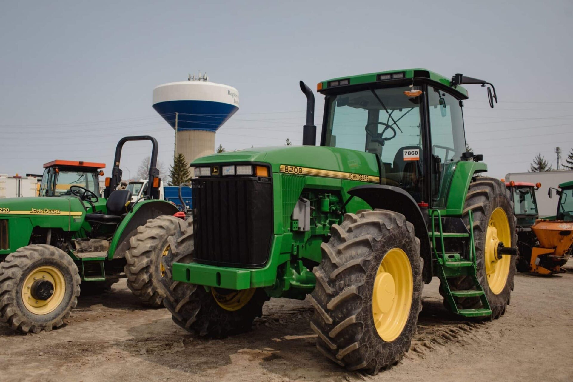 John Deere tractors in a lot during a Ritchie Bros heavy equipment auction in Bolton, Ontario, Canada, on Tuesday, May 9, 2023. Ritchie Bros Auctioneers Inc., a Canadian firm that sells heavy equipment at auctions around North America, struck an agreement in November to buy IAA, which sells damaged and written-off vehicles.