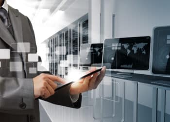 Business man hand controls computer room