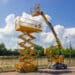 Yellow self propelled articulated boom lift and scissor lift on background of street with trees and sky. Alta equipment sales revenue up 45% YoY.