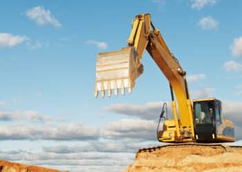 Excavator loader machine with risen boom construction site. CNH Industrial Capital outstandings up 18%