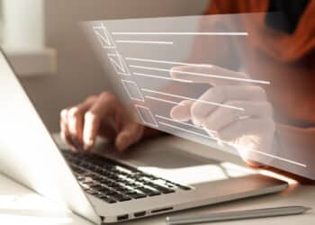 Online documentation database and document management system concept. businesswoman working on laptop with virtual screen. process automation to efficiently manage files.