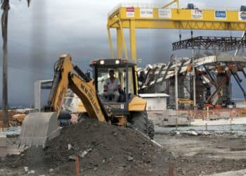 A worker operates a New Holland backhoe loader during construction at the Porto Maravilha project in Rio de Janeiro, Brazil, on Thursday, Jan. 22, 2015. With the main projects at the port scheduled for completion before the 2016 Olympics, Rio de Janeiro Mayor Eduardo Paes aims to redraw the image of the city and reinvent a dilapidated region by luring residents and companies.