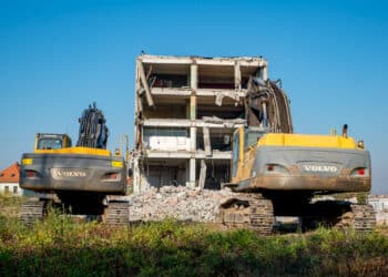 building under demolition with Volvo hydraulic excavator