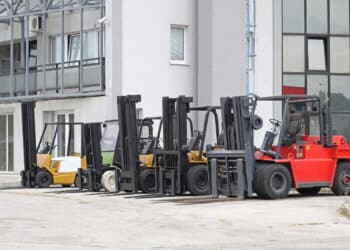 Forklift trucks in front of distribution warehouse