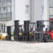 Forklift trucks in front of distribution warehouse