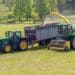 Kaplice, czech republic - 06 02 2021: self-propelled forage harvester and tractor with silage trailer in the field