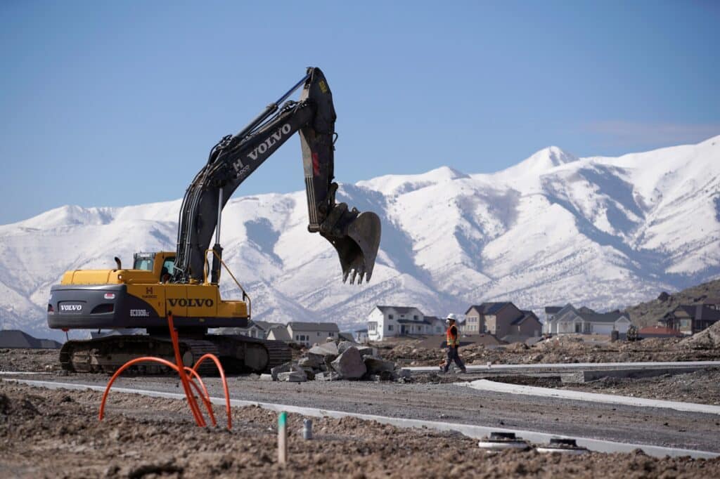 A worker uses a Volvo AB excavator to build a road during construction in Saratoga Springs, Utah, U.S., on Tuesday, March 12, 2019. The National Association of Home Builders (NAHB) released housing market index figures on March 18.