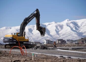 A worker uses a Volvo AB excavator to build a road during construction in Saratoga Springs, Utah, U.S., on Tuesday, March 12, 2019. The National Association of Home Builders (NAHB) released housing market index figures on March 18.