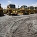 Track marks scar the ground near a row of Caterpillar Inc. equipment at the Altorfer Cat dealership in East Peoria, Illinois, U.S., on Tuesday, July 21, 2015. Caterpillar Inc. is scheduled to report quarterly earnings on July 23.