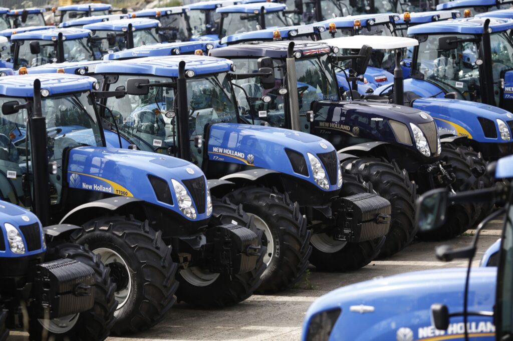 Newly manufactured New Holland T6 and T7 tractors stand parked in a yard ahead of shipping at CNH Industrial NV's assembly plant in Basildon, U.K., on Wednesday, July 2, 2014. CNH Industrial plans to more than double profit by 2018 as the maker of Iveco trucks and New Holland tractors sets its sights on expansion in Asia.