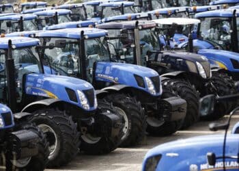 Newly manufactured New Holland T6 and T7 tractors stand parked in a yard ahead of shipping at CNH Industrial NV's assembly plant in Basildon, U.K., on Wednesday, July 2, 2014. CNH Industrial plans to more than double profit by 2018 as the maker of Iveco trucks and New Holland tractors sets its sights on expansion in Asia.