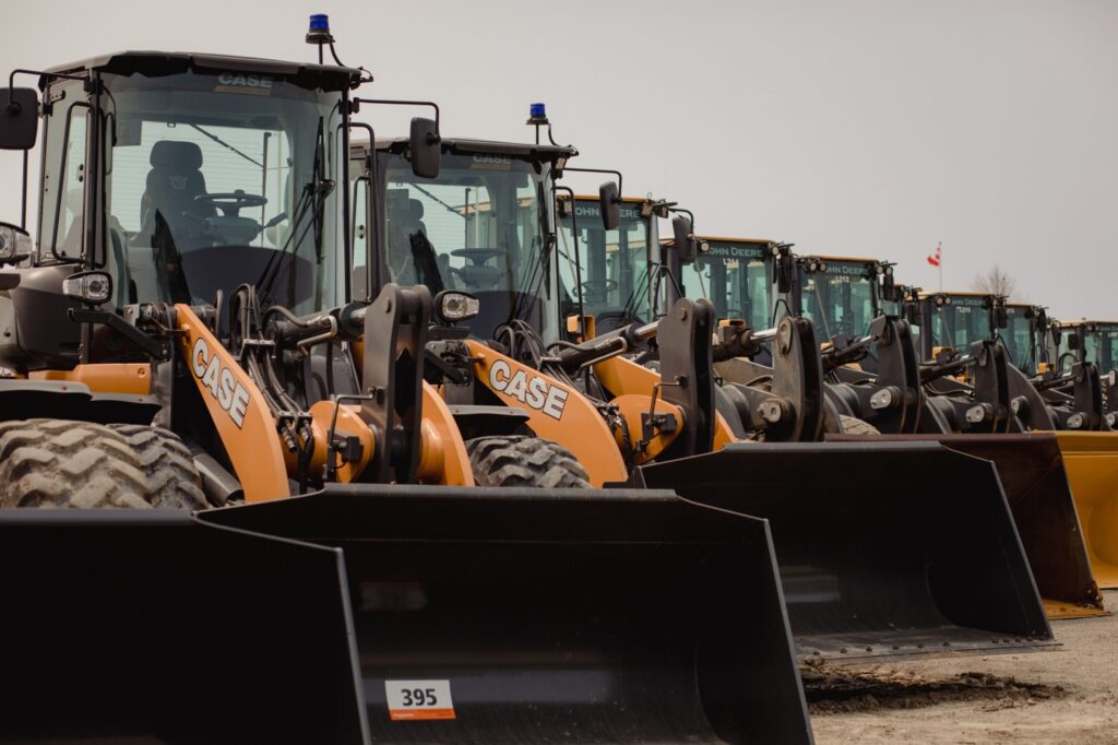 Wheel loaders in the lot during a Ritchie Bros heavy equipment auction in Bolton, Ontario, Canada, on Tuesday, May 9, 2023. Ritchie Bros Auctioneers Inc., a Canadian firm that sells heavy equipment at auctions around North America, struck an agreement in November to buy IAA, which sells damaged and written-off vehicles.