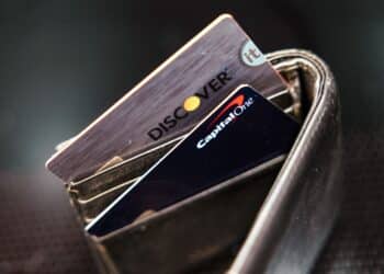 Capital One and Discover credit cards arranged in Germantown, New York, US, on Tuesday, Feb. 20, 2024. Capital One Financial Corp. agreed to buy Discover Financial Services in a $35 billion all-stock deal to create the largest US credit card company by loan volume, giving the combined entity a stronger foothold to compete with Wall Streets behemoths.