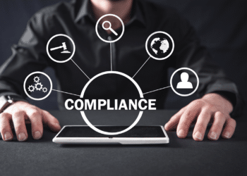 man with compliance in foreground and ipad