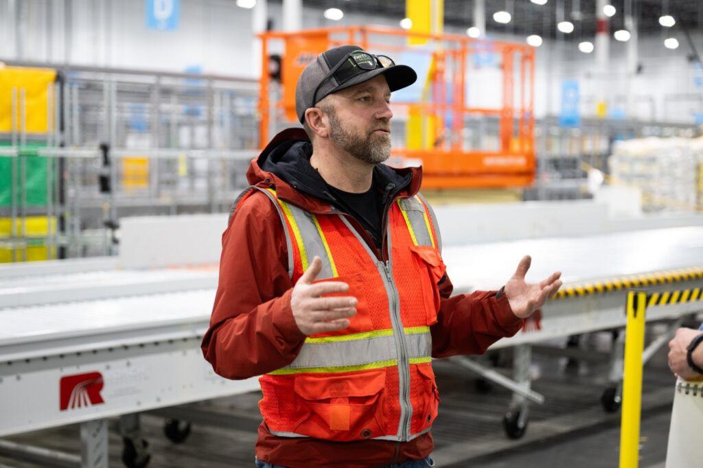 Amazon’s Maple Valley, Washington, warehouse is built for speed. At night, big rigs pull up to one end to unload boxes and padded mailers – some after a short drive from a bigger warehouse down the road, others following a flight in the hold of a cargo plane. Waiting employees scan, sort and load them into rolling racks.    