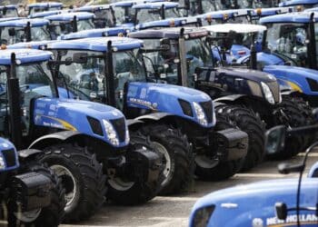 Newly manufactured New Holland T6 and T7 tractors stand parked in a yard ahead of shipping at CNH Industrial NV's assembly plant in Basildon, U.K., on Wednesday, July 2, 2014. CNH Industrial plans to more than double profit by 2018 as the maker of Iveco trucks and New Holland tractors sets its sights on expansion in Asia.