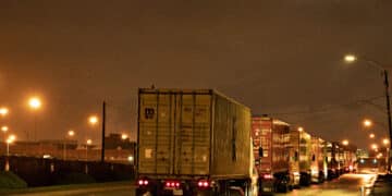 Tractor-trailer trucks wait to enter the Port of Baltimore in Baltimore, Maryland, U.S., on Monday, March 23, 2020. A shipping container shortage that's left everything from Thai curry to Canadian peas idling in ports may be about to get a whole lot worse as China steps up its coronavirus precautions on incoming vessels.