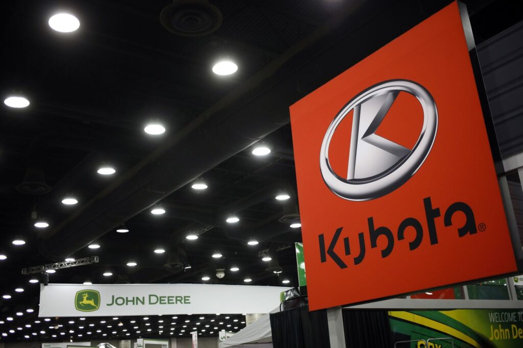 Kubota Corp. and Deere & Co. brand John Deere signage at the National Farm Machinery Show in Louisville, Kentucky, U.S., on Friday, Feb. 18, 2022. The National Farm Machinery Show has 900 exhibitor booths, making it the countrys largest indoor farm show.