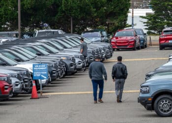 Customers view used Ford vehicles at a dealership in Colma, California, US, on Friday, June 21, 2024. CDK Global, a software provider to some 15,000 car dealers, was waylaid by debilitating cyberattacks this week that have had a crippling effect on the auto sales industry.