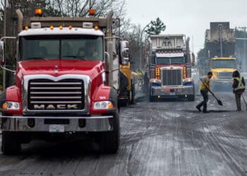 A paving crew lays down new tarmac on a road in Victoria, British Columbia, Canada, on Thursday, March 24, 2022. The province is working to bring roads and highways back to full capacity after record-breaking amounts of rain last November.