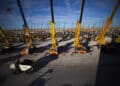 Truck cranes stand on display among other heavy construction machinery for sale at the Ritchie Bros. auction in Ocana, Spain, on Thursday, Sept. 13, 2012. Spain's Prime Minister Mariano Rajoy, who has been calling for central bank purchases of government bonds since taking office in December, has spent six weeks hesitating since ECB President Mario Draghi said Aug. 2 that any aid would have conditions attached.