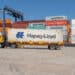 A semi-truck hauls a container at the Sociedad Portuaria Regional de Cartagena (SPRC) terminal at the Port of Cartagena in Cartagena, Colombia, on Thursday, Dec. 9, 2021. Colombia's exports rose to $3.795b in October from $3.573b in September.