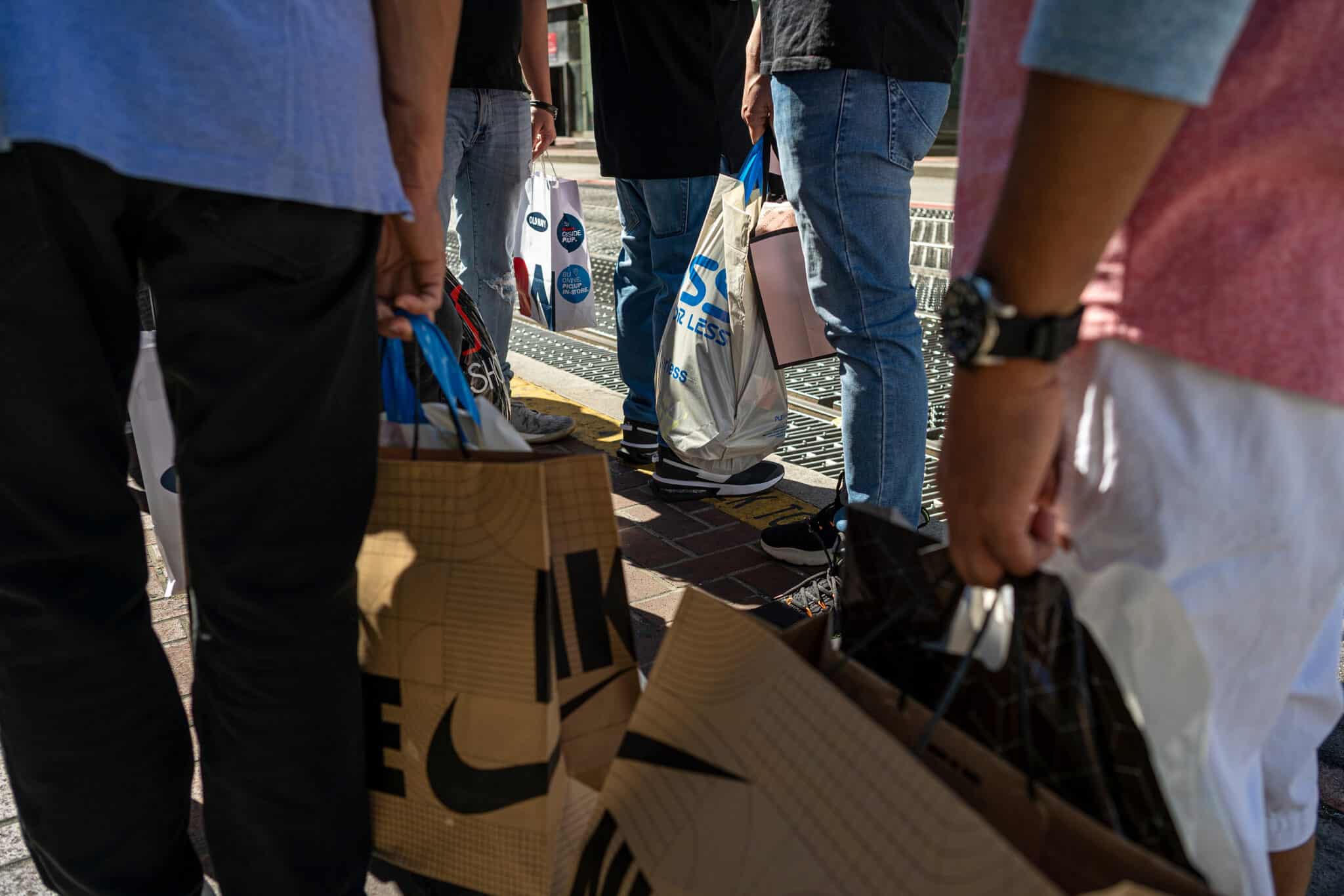 Pedestrians with shopping bags in San Francisco, California, US, on Thursday, Sept. 29, 2022. US consumer confidence rose for a second month in September to the highest since April, indicating a strong job market and lower gas prices are contributing to more optimistic views of the economy.