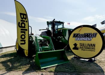 Deere & Co. farm equipment near BigIron Auction signage at the Farm Progress Show.