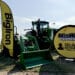 Deere & Co. farm equipment near BigIron Auction signage at the Farm Progress Show.
