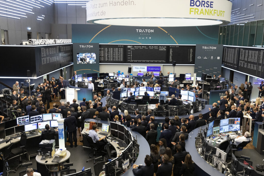 Attendees and traders fill the trading floor as Volkwagen AG's Traton SE truck unit makes its initial public offering (IPO) at the Frankfurt Stock Exchange, operated by Deutsche Boerse AG, in Frankfurt, Germany, on Friday, June 28, 2019. Volkswagen raised 1.55 billion euros ($1.8 billion) selling a stake in its trucks business, but only after pricing the offer at the low end of a target range to attract investors to one of Europes biggest initial public offerings this year.