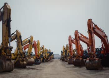 Excavators in a lot during a Ritchie Bros heavy equipment auction in Bolton, Ontario, Canada, on Tuesday, May 9, 2023. Ritchie Bros Auctioneers Inc., a Canadian firm that sells heavy equipment at auctions around North America, struck an agreement in November to buy IAA, which sells damaged and written-off vehicles.