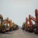 Excavators in a lot during a Ritchie Bros heavy equipment auction in Bolton, Ontario, Canada, on Tuesday, May 9, 2023. Ritchie Bros Auctioneers Inc., a Canadian firm that sells heavy equipment at auctions around North America, struck an agreement in November to buy IAA, which sells damaged and written-off vehicles.