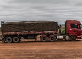A driver secures a tarp over soy before exiting a farm near Capixaba, Acre state, Brazil, on Tuesday, May, 28, 2024. As farmers move deeper into the Amazon to meet global demand for soy, corn and sugar, geoglyphs are being destroyed just as fast as they're being discovered.