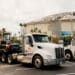 A truck pulls construction equipment in front of Tropicana Field after Hurricane Milton in St. Petersburg, Florida, US, on Friday, Oct. 11, 2024. Hurricane Miltons devastating path across Florida has left at least 10 dead, millions without power, and destroyed homes and crops, as authorities warn it could take days to assess the full extent of the damages.