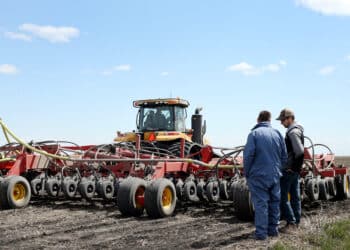 An AGCO Corp. Challenger tractor pulls a Bourgault Tillage Tools Ltd. air seeder while planting canola seeds on a farm near St. Francois Xavier, Manitoba, Canada on Thursday, May 9, 2019. Prime Minister Justin Trudeau's government is expanding a loan program for farmers and launching a trade mission to Japan and South Korea as Canadian canola exports get caught up in a diplomatic feud with China.