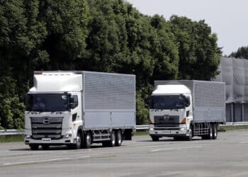 Hino Motors Ltd. autonomous trucks travel in convoy during a demonstration at a test course in Hamura, Tokyo Metropolis, Japan, on Monday, May 21, 2018. The Japanese bus and truck maker said today it will aim to have vehicles capable of complete self-driving in limited areas as soon as 2025, including driverless convoys.