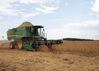 A farmer operates a Deere & Co. combine to harvest soybeans in Ita, Sao Paulo state, Brazil, on Wednesday, Feb. 24, 2021. The impact of Brazils late soybean harvest has hit the roads of the nations northern export route, ensnaring truckers in long lines and threatening further delays ofshipmentsto China.