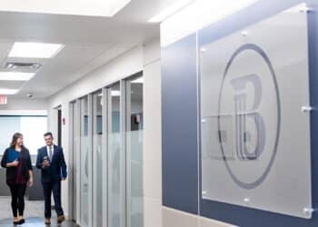 Man Woman Walking Busey Hallway