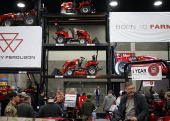 Attendees view AGCO Corp. Massey Ferguson tractors at the National Farm Machinery Show in Louisville, Kentucky, U.S., on Friday, Feb. 18, 2022. The National Farm Machinery Show has 900 exhibitor booths, making it the countrys largest indoor farm show.