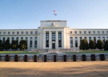 Fed holds rates, sees slower growth and higher inflation