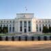 Fed holds rates, sees slower growth and higher inflation