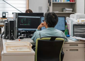 An office worker studies electronic diagrams on a computer at control-panel maker Hinoden Electric Industries Ltd., in Matsue, Shimane, Japan, on Friday, July 12, 2024. After decades of deflation, many smaller companies dont know how to ask for more money, preventing a healthy wage-price cycle from taking root.