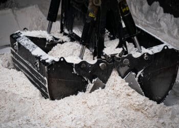 An excavator picks up wet cake from a barge to move it to a dump truck at the Port of Little Rock in Little Rock, Arkansas, US, on Thursday, April 3, 2025. Wall Street economists said the US risks a recession this year and inflation could return to pandemic levels following the Trump administrations announcement of major tariffs on global trading partners. PEAC