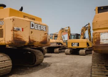 Excavators in a lot during a Ritchie Bros heavy equipment auction in Bolton, Ontario, Canada, on Tuesday, May 9, 2023. Ritchie Bros Auctioneers Inc., a Canadian firm that sells heavy equipment at auctions around North America, struck an agreement in November to buy IAA, which sells damaged and written-off vehicles. RB Global