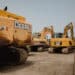 Excavators in a lot during a Ritchie Bros heavy equipment auction in Bolton, Ontario, Canada, on Tuesday, May 9, 2023. Ritchie Bros Auctioneers Inc., a Canadian firm that sells heavy equipment at auctions around North America, struck an agreement in November to buy IAA, which sells damaged and written-off vehicles. RB Global