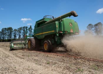 A farmer operates a Deere & Co. combine to harvest soybeans in Santa Cruz do Rio Pardo, Sao Paulo state, Brazil, on Saturday, March 7, 2020. Soybean and corn futures slumped as the tumbling real boosted the allure of exports from crop giant Brazil, while coronavirus woes weighted on commodity markets.