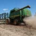 A farmer operates a Deere & Co. combine to harvest soybeans in Santa Cruz do Rio Pardo, Sao Paulo state, Brazil, on Saturday, March 7, 2020. Soybean and corn futures slumped as the tumbling real boosted the allure of exports from crop giant Brazil, while coronavirus woes weighted on commodity markets.