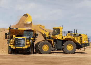 Core Machinery: A WA700 wheel loader deposits a load into an HD605-10 haul truck at Komatsu's Arizona Proving Grounds in Sahuarita, Arizona.