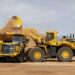 Core Machinery: A WA700 wheel loader deposits a load into an HD605-10 haul truck at Komatsu's Arizona Proving Grounds in Sahuarita, Arizona.